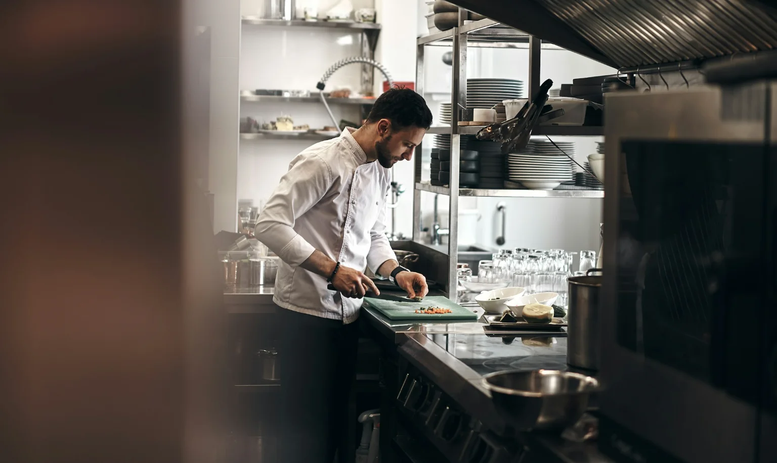 A chef coordinating work at the kitchen pass